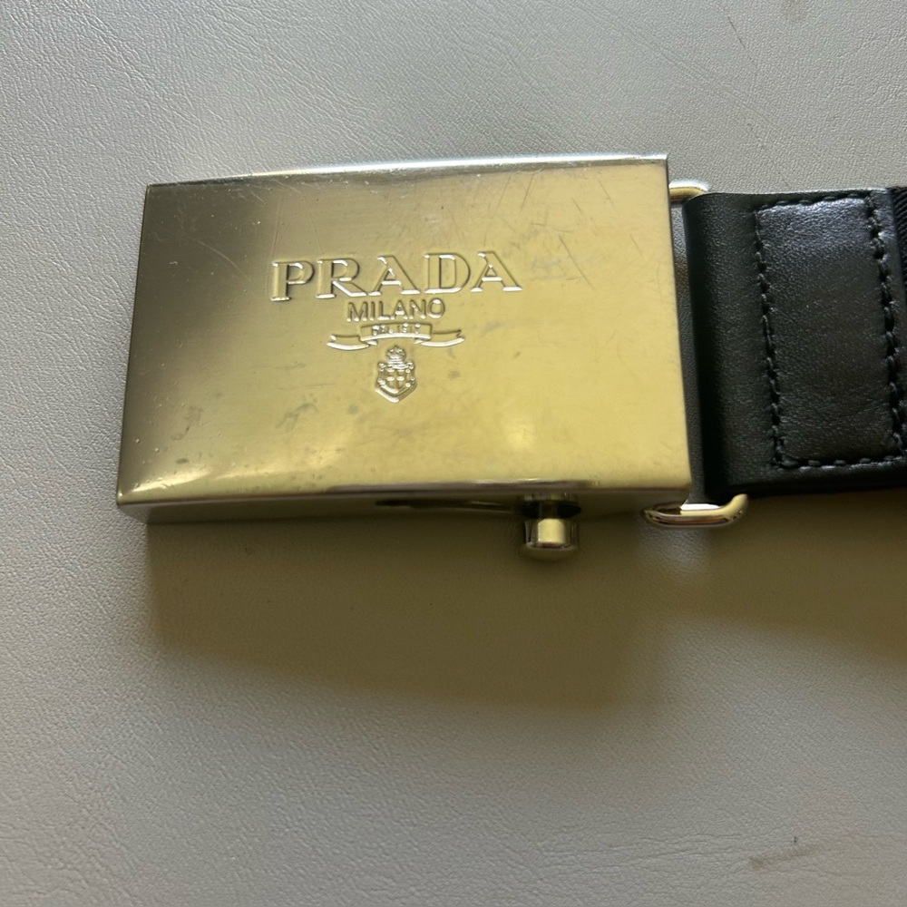 Authentic unisex Prada Metallic Silver buckle and Black canvas belt.